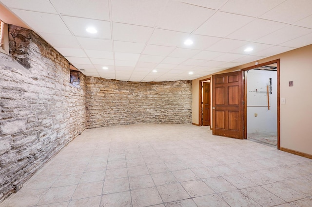 basement featuring a paneled ceiling