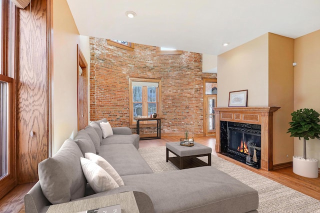 living room with a premium fireplace and light hardwood / wood-style flooring