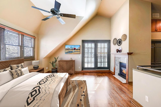 bedroom featuring vaulted ceiling, light hardwood / wood-style flooring, and ceiling fan