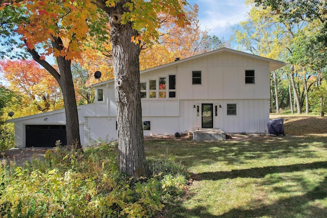 view of front of property with a garage and a front lawn