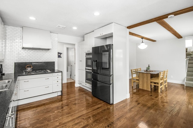 kitchen featuring black gas stovetop, custom exhaust hood, refrigerator with ice dispenser, beam ceiling, and white cabinetry