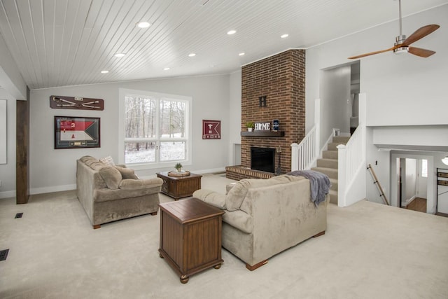 living room featuring ceiling fan, lofted ceiling, light carpet, a fireplace, and wood ceiling