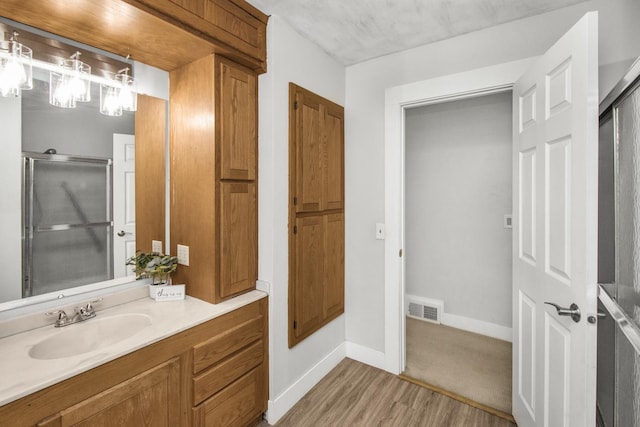 bathroom with hardwood / wood-style floors and vanity