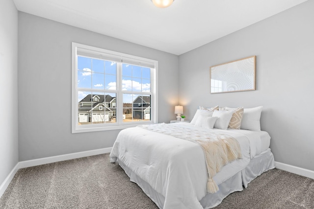 bedroom with baseboards and carpet floors