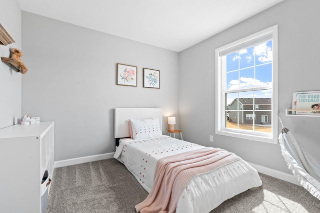 bedroom with carpet flooring and baseboards