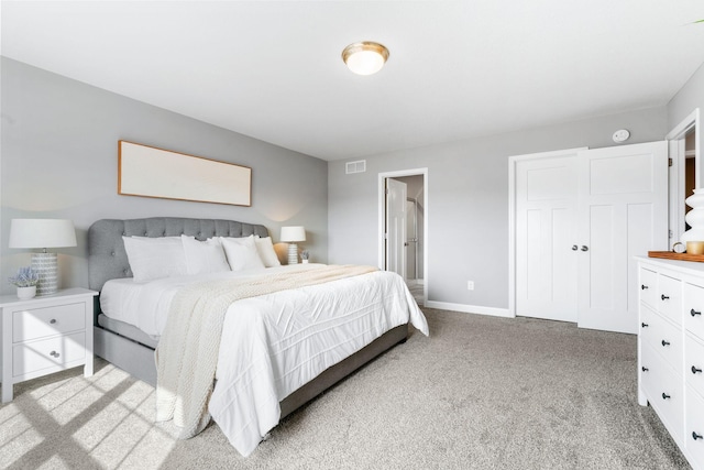 bedroom with light carpet, visible vents, and baseboards