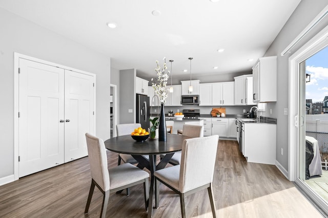 dining room featuring recessed lighting, baseboards, and wood finished floors