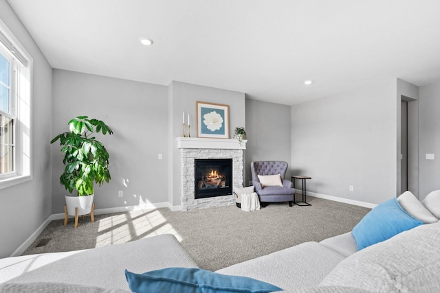 carpeted living room with visible vents, recessed lighting, a fireplace, and baseboards