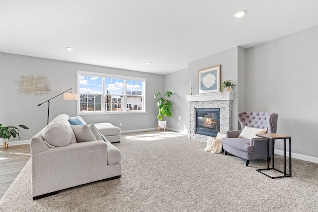 living area with recessed lighting, a fireplace, and baseboards