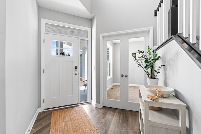 entryway with french doors, baseboards, and wood finished floors