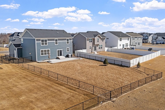 view of yard with a patio, a fenced backyard, and a residential view