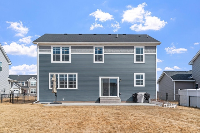 rear view of house featuring entry steps, a lawn, a fenced backyard, a patio area, and a gate