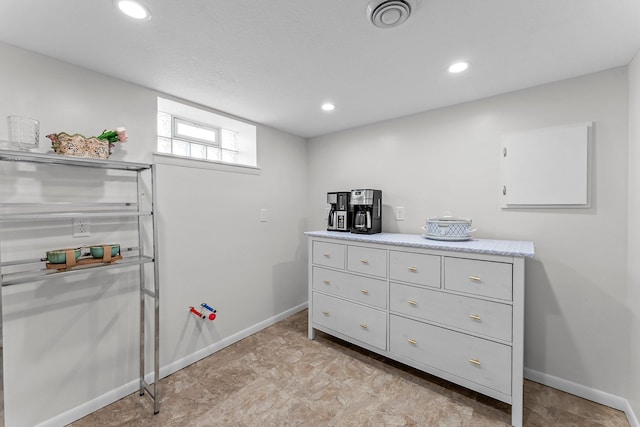 interior space featuring recessed lighting, baseboards, and visible vents