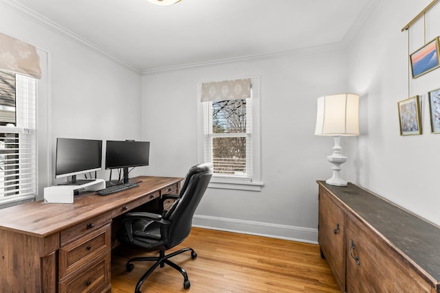 office space with baseboards, light wood-style flooring, and ornamental molding