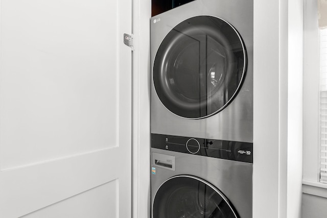 washroom featuring laundry area and stacked washing maching and dryer