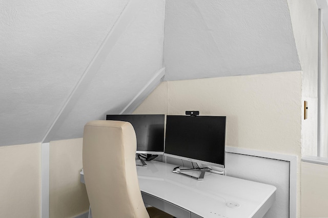 office space with lofted ceiling and built in study area