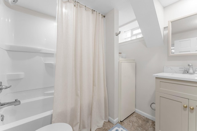 bathroom with toilet, vanity, baseboards, and shower / bath combo