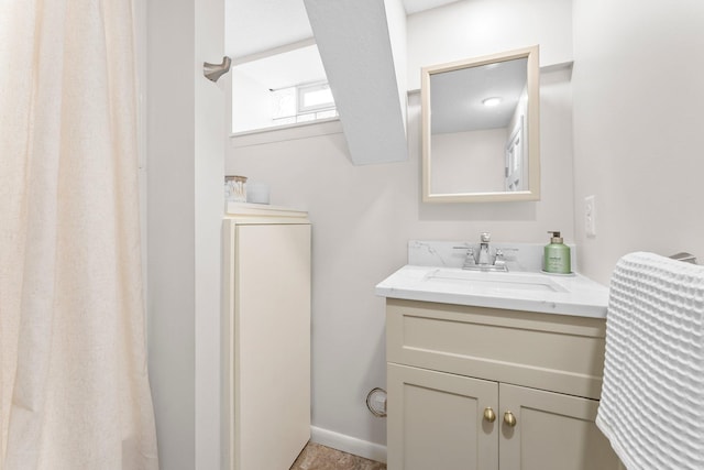 bathroom with vanity and baseboards