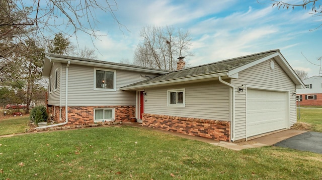 view of front of house featuring a garage and a front lawn