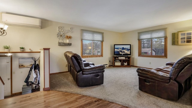 living room featuring a wall unit AC and hardwood / wood-style flooring