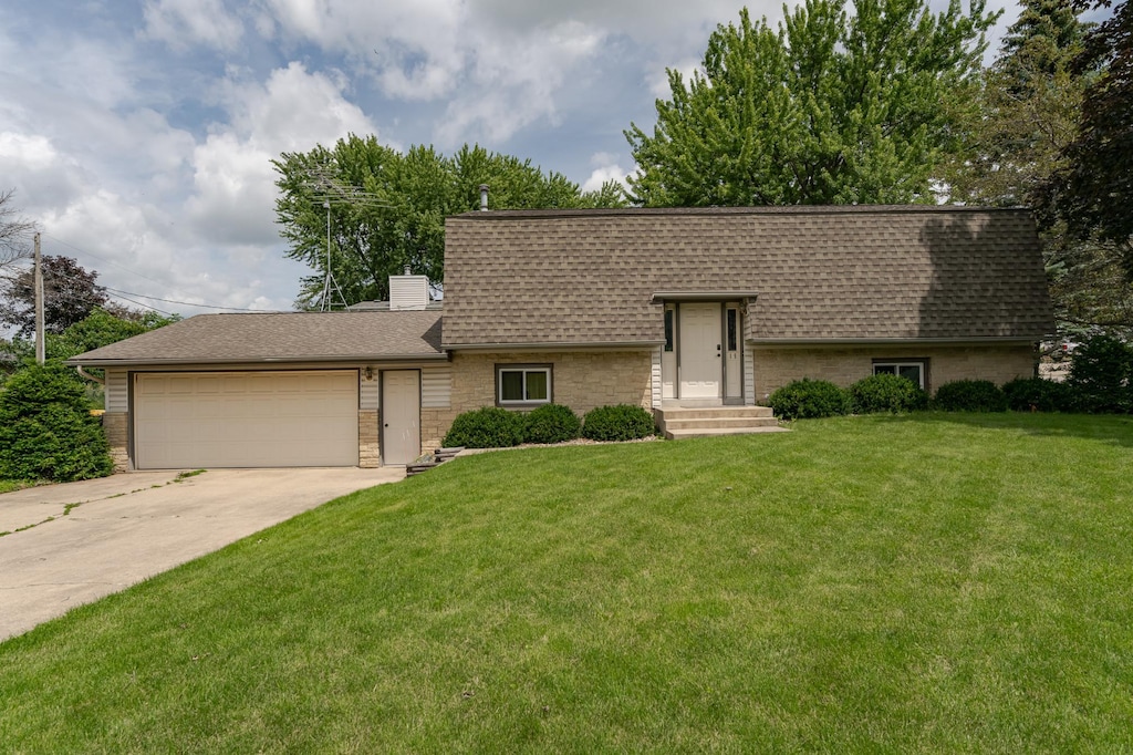 ranch-style house with a front lawn and a garage