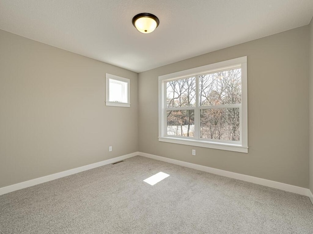 unfurnished room featuring carpet flooring