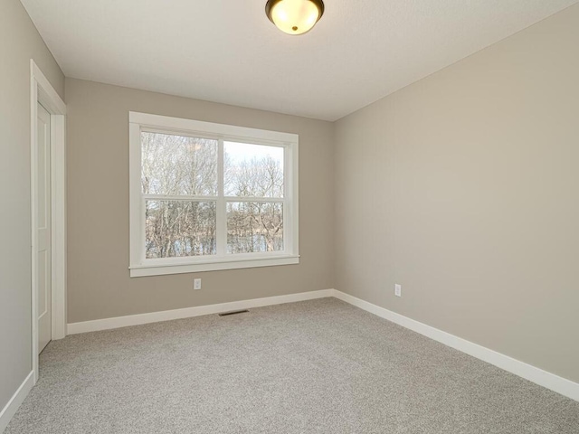 unfurnished room featuring carpet