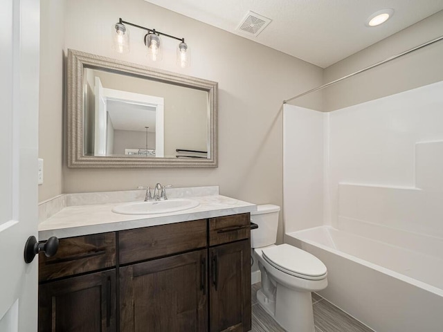 full bathroom featuring vanity, shower / bath combination, and toilet