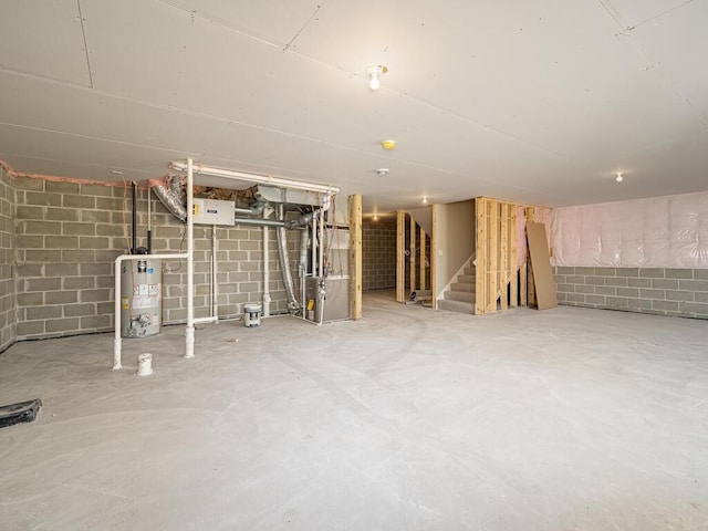 basement featuring gas water heater and heating unit