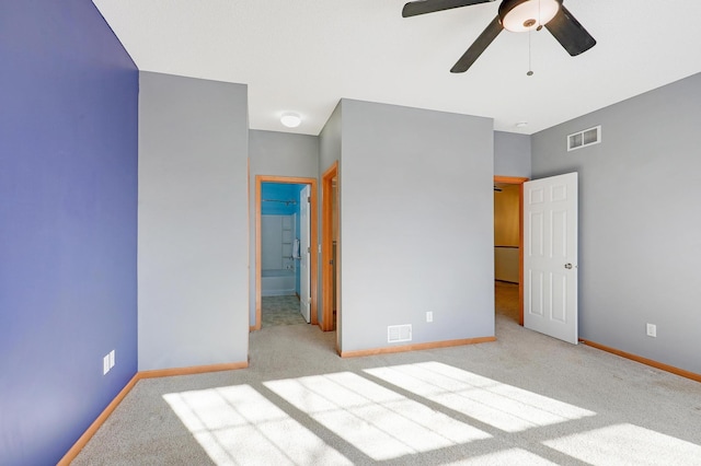 unfurnished bedroom featuring light colored carpet and ceiling fan