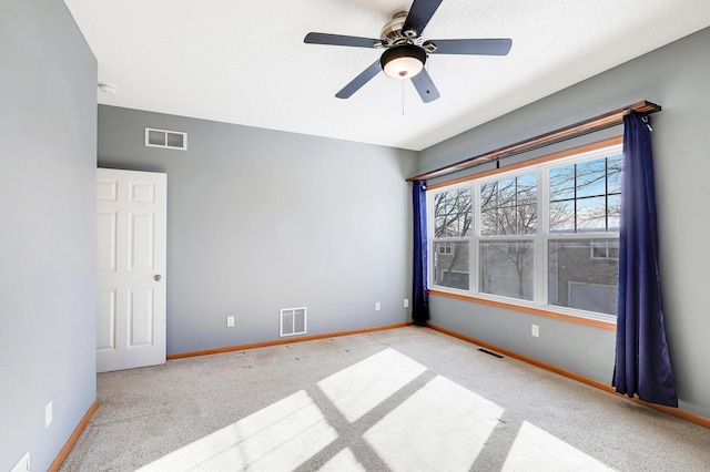 unfurnished room featuring light colored carpet and ceiling fan