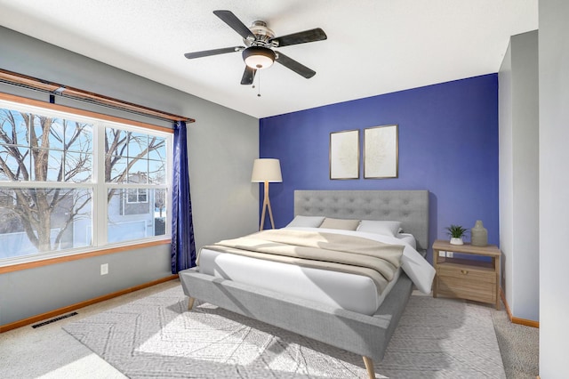 bedroom featuring light colored carpet and ceiling fan