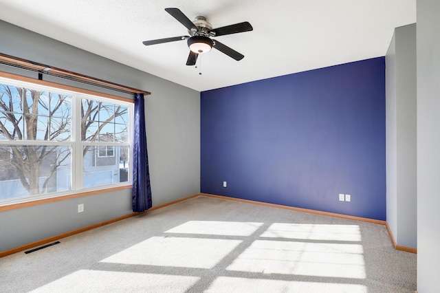 carpeted empty room featuring ceiling fan