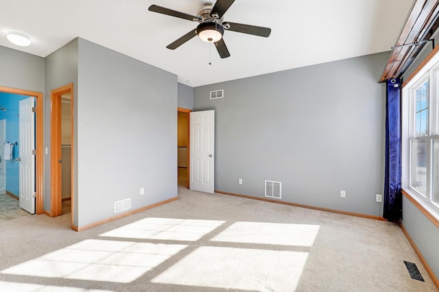 unfurnished bedroom featuring light carpet and ceiling fan