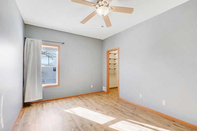 empty room featuring ceiling fan and light hardwood / wood-style floors