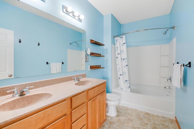 full bathroom with vanity, shower / tub combo, and toilet