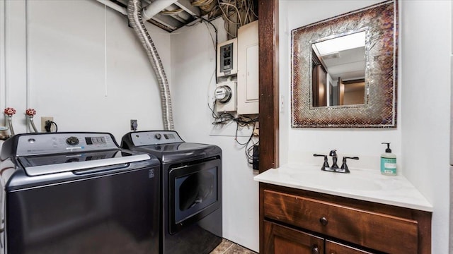 laundry area with washing machine and clothes dryer and sink