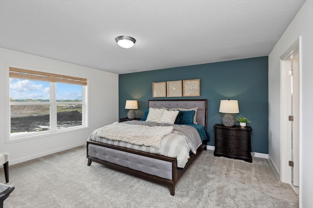 carpeted bedroom featuring a textured ceiling