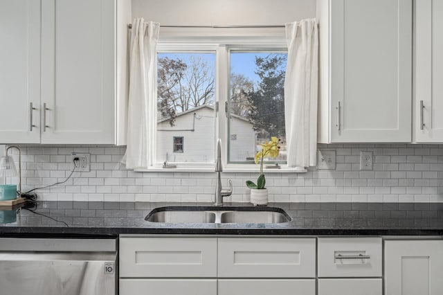 kitchen with tasteful backsplash, sink, white cabinets, and dishwasher