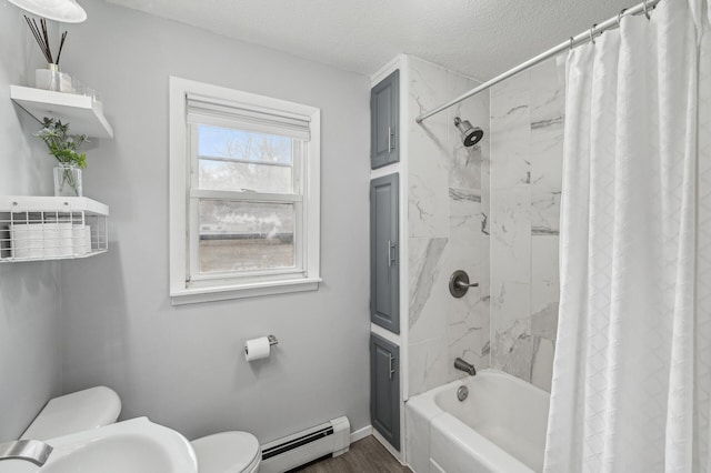 full bathroom with sink, hardwood / wood-style flooring, a baseboard heating unit, shower / tub combo, and a textured ceiling