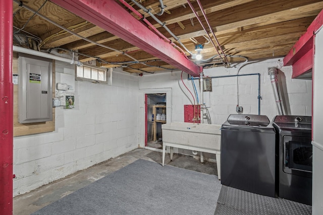 basement with sink, electric panel, and washing machine and dryer