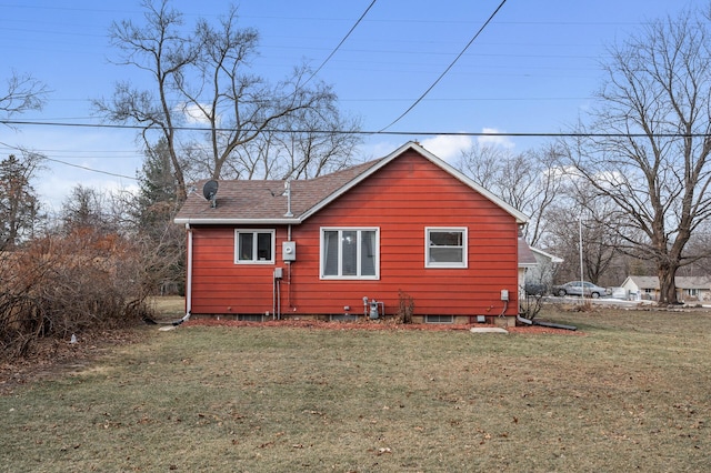 rear view of property with a yard