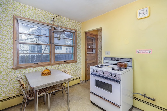 kitchen with white gas stove and baseboard heating