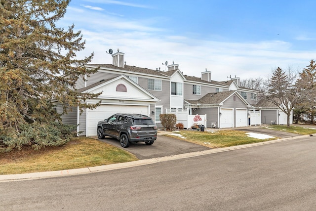 view of front of house with a garage and aphalt driveway