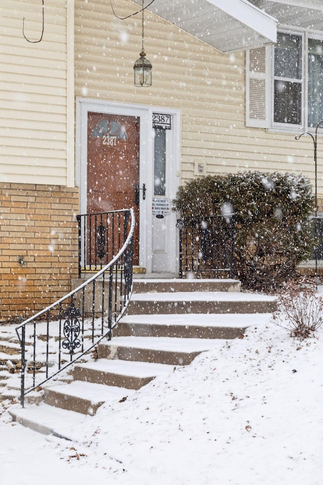 view of snow covered property entrance