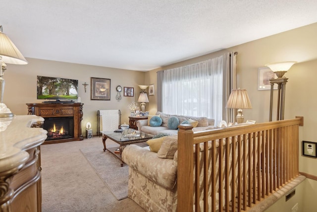 carpeted living room featuring a textured ceiling