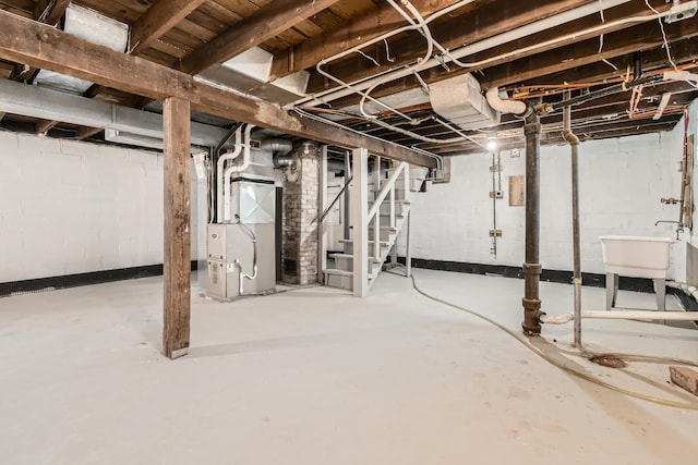 basement with sink and heating unit