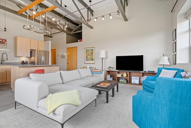 living room featuring a towering ceiling and sink