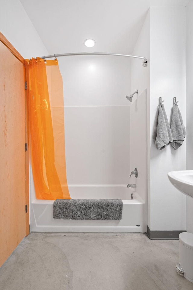 bathroom featuring shower / bath combination with curtain and concrete floors