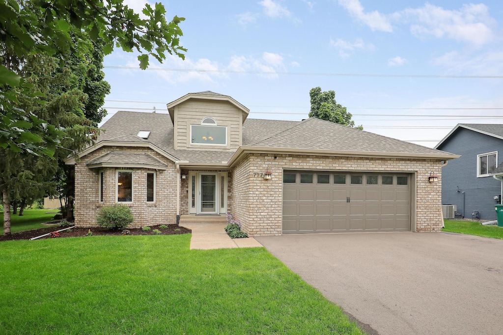 view of front of house with a front yard and a garage